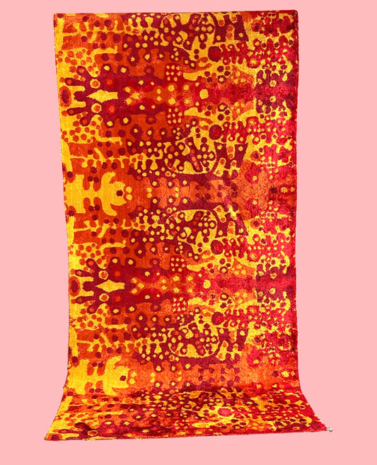 Vivid, abstract wall carpet in red/orange/yellow with organic shapes
