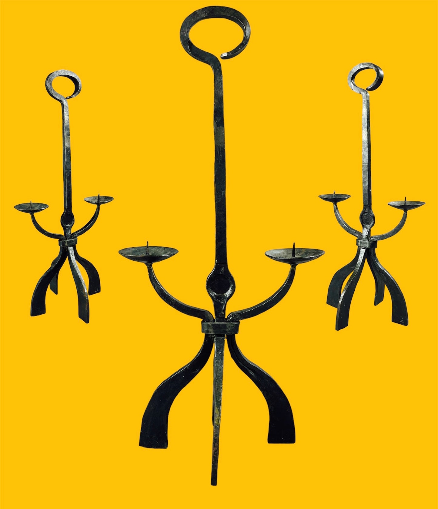 Wrought iron double candelabra with four legs and a top handle