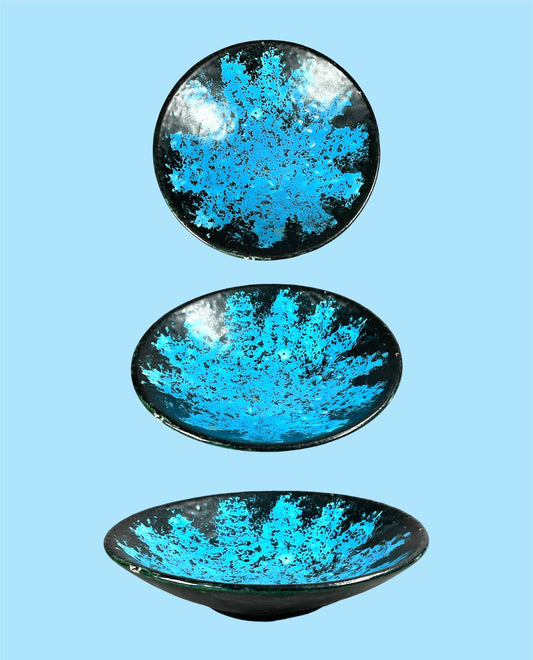 Small black ceramic plate with neon blue decor