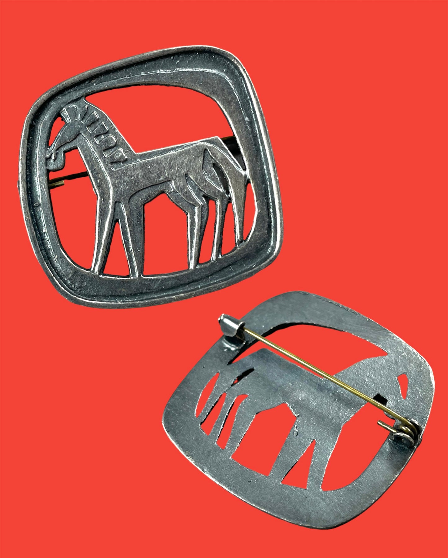 Metal stylized "Colts" brooch