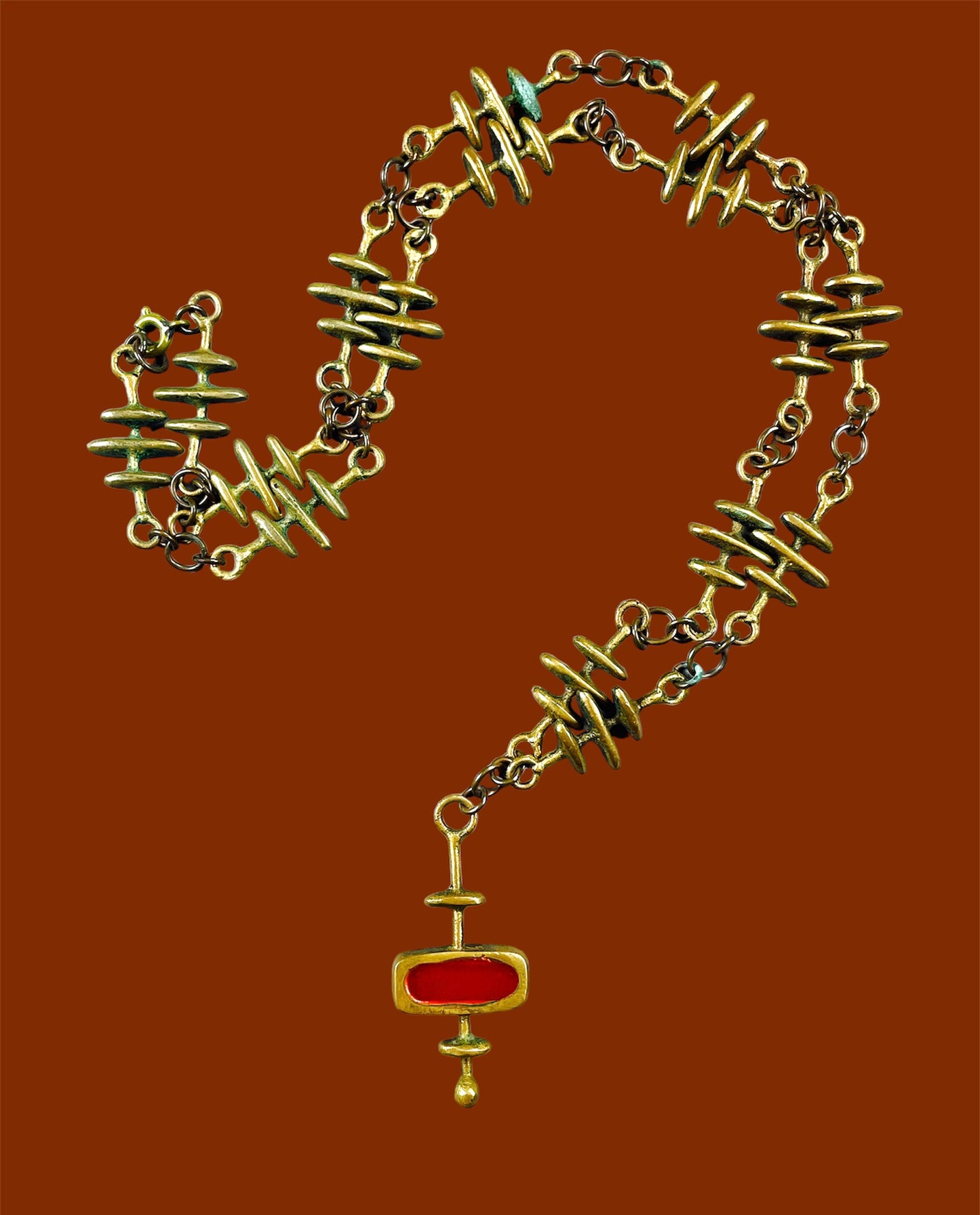 Yellow copper decorated chain and abstract geometric pendant with red enamel